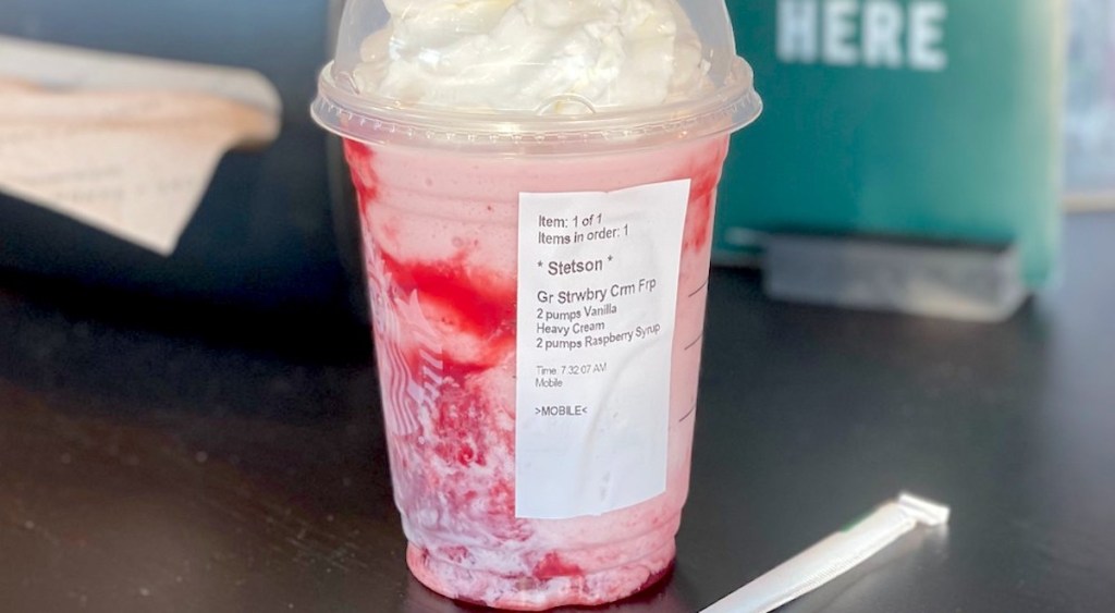 starbucks skittles frappuccino with order sticker sitting on countertop