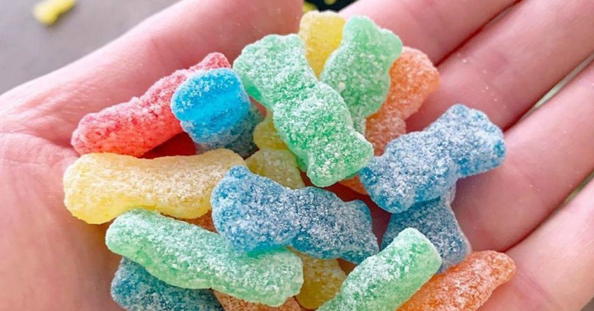 sour patch kids in the palm of a hand