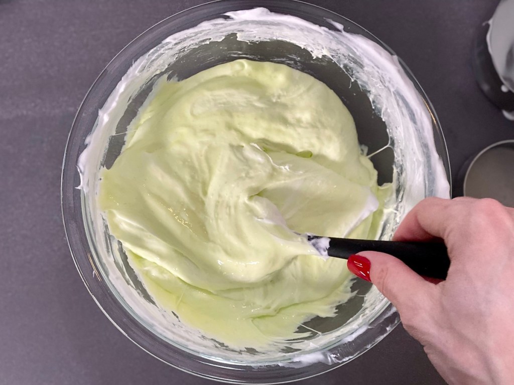 green slime being stirred in a glass bowl