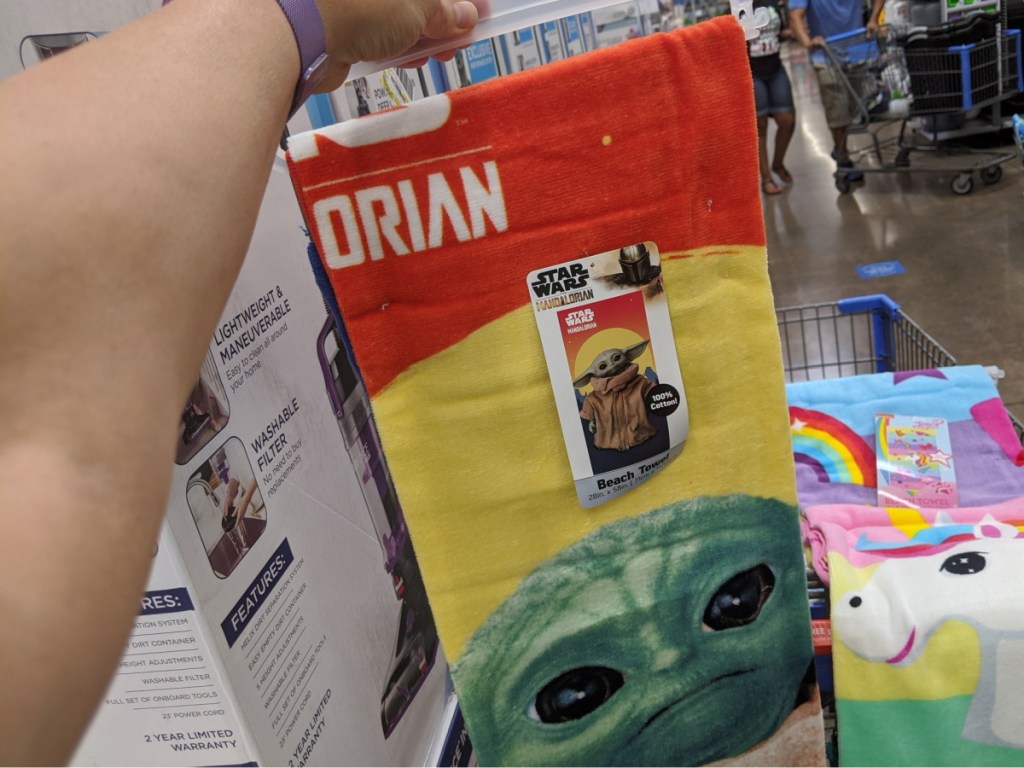 hand holding towel with Star Wars character on it