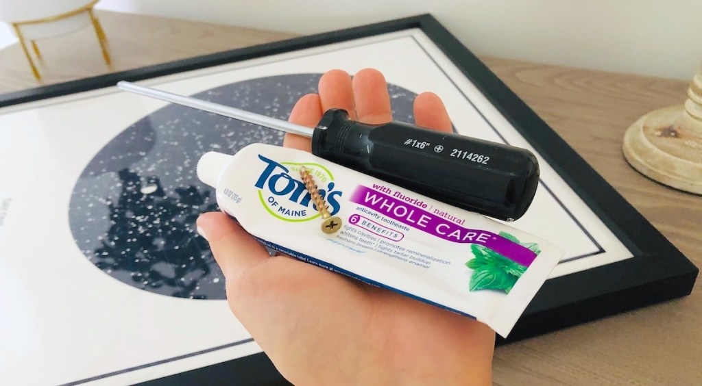 Life Hack: Use Toothpaste to Hang a Picture Frame Perfectly - Hip2Save