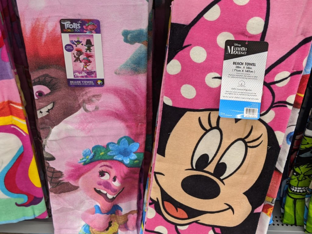 pink towels with fun characters for kids on them in store