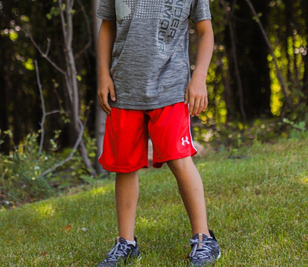 boy wearing red shorts and gray tee