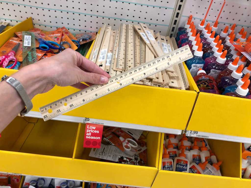 woman hand holding up and up wood ruler