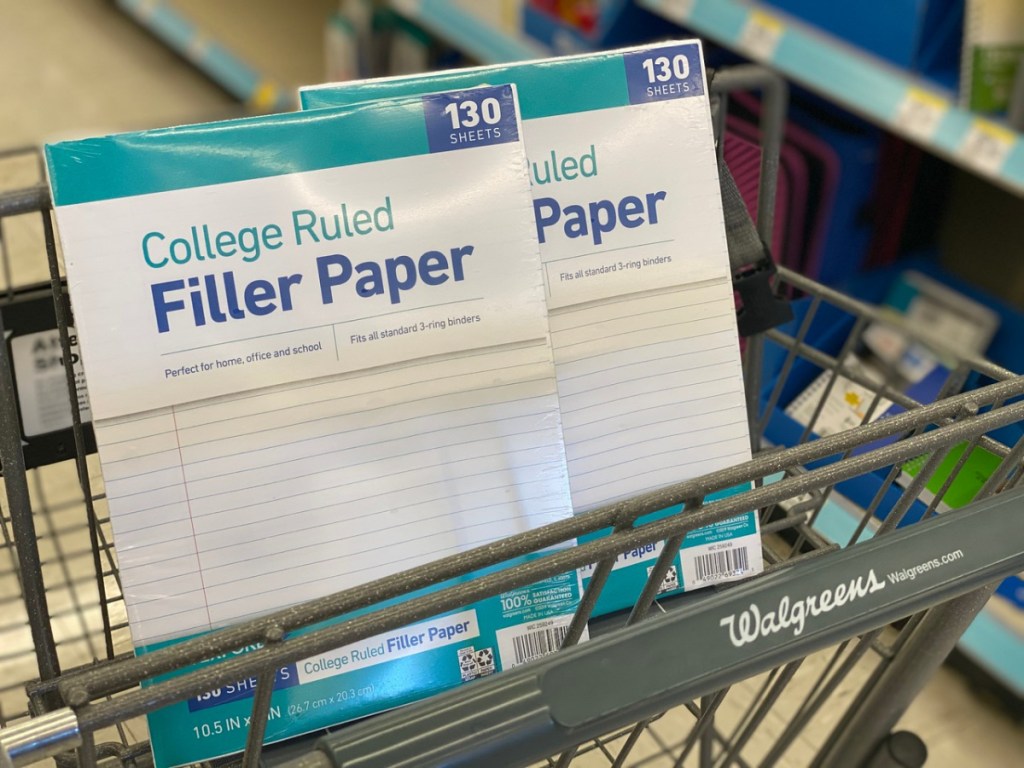 grocery cart with 2 packs of filler paper in the seat