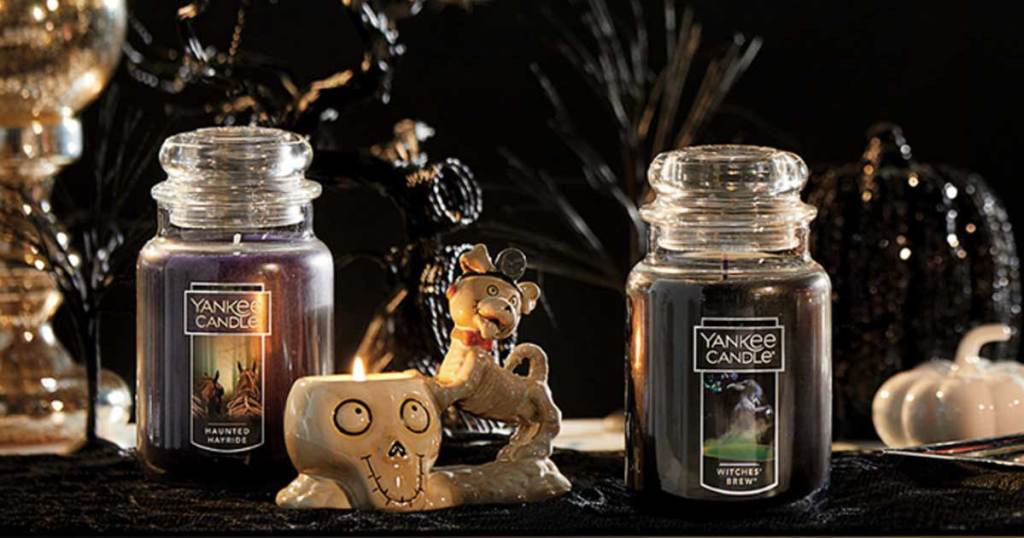 halloween scene with black candles and a skeleton 
