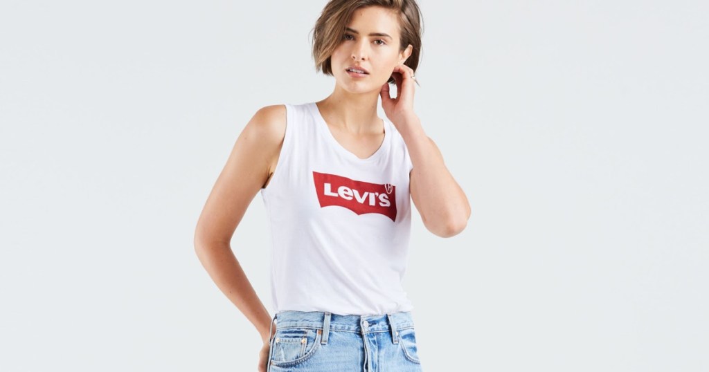 woman wearing white tank with levis logo