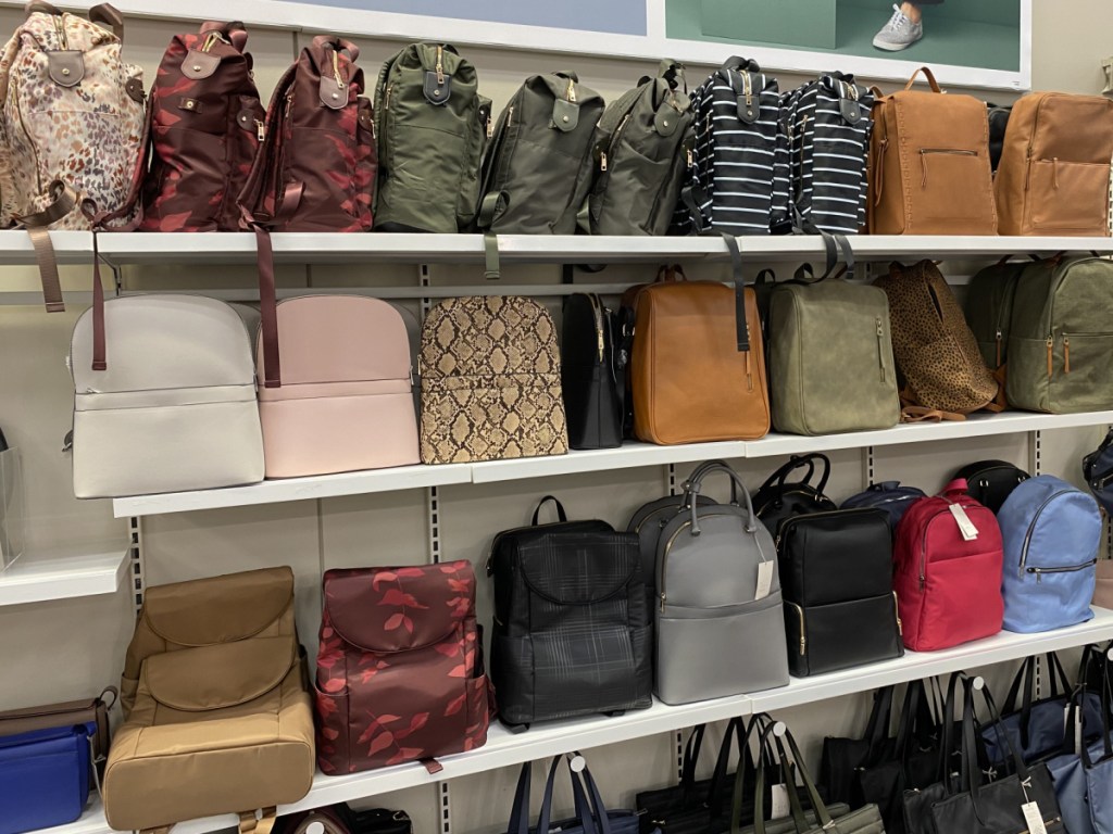various handbags and backpacks on store shelves