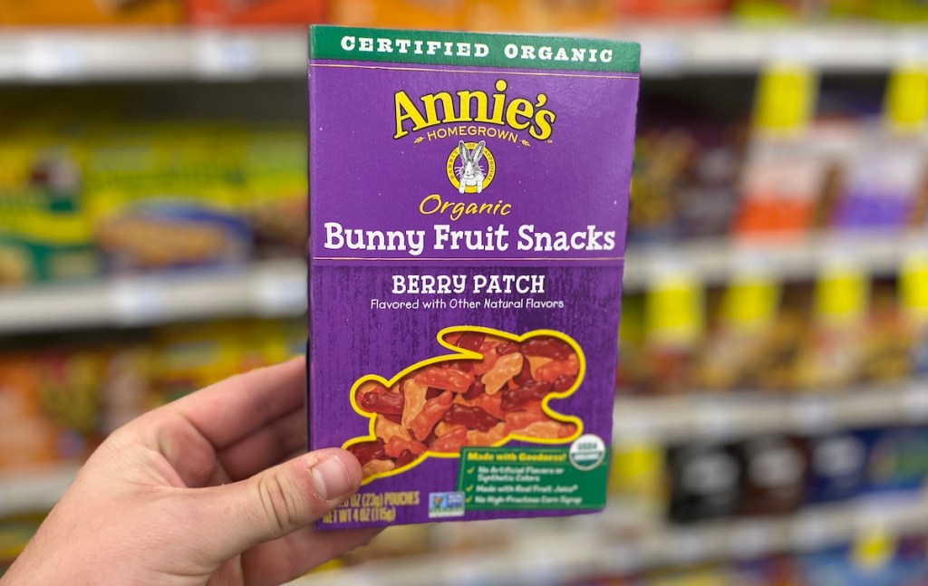 hand holding a box of Annie's fruit snacks