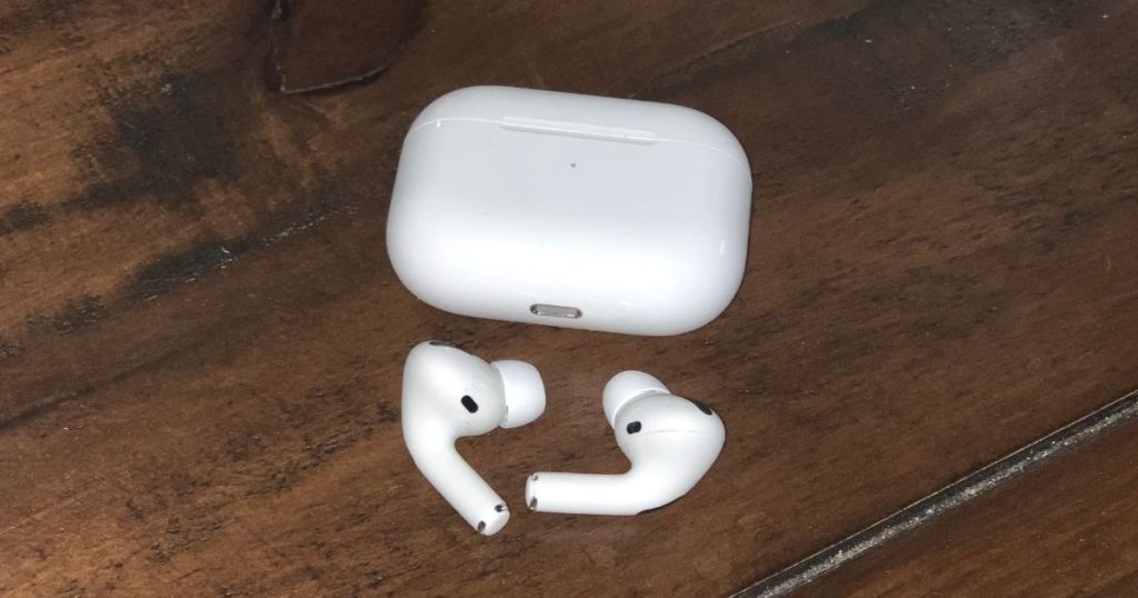 airpod pros case with ear buds on counter top