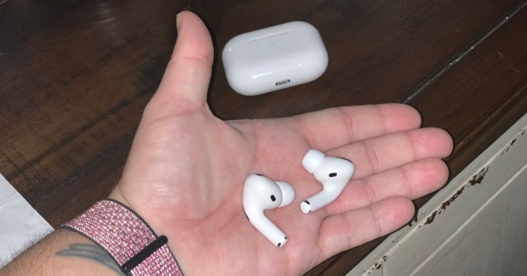 hand holding apple airpod pros