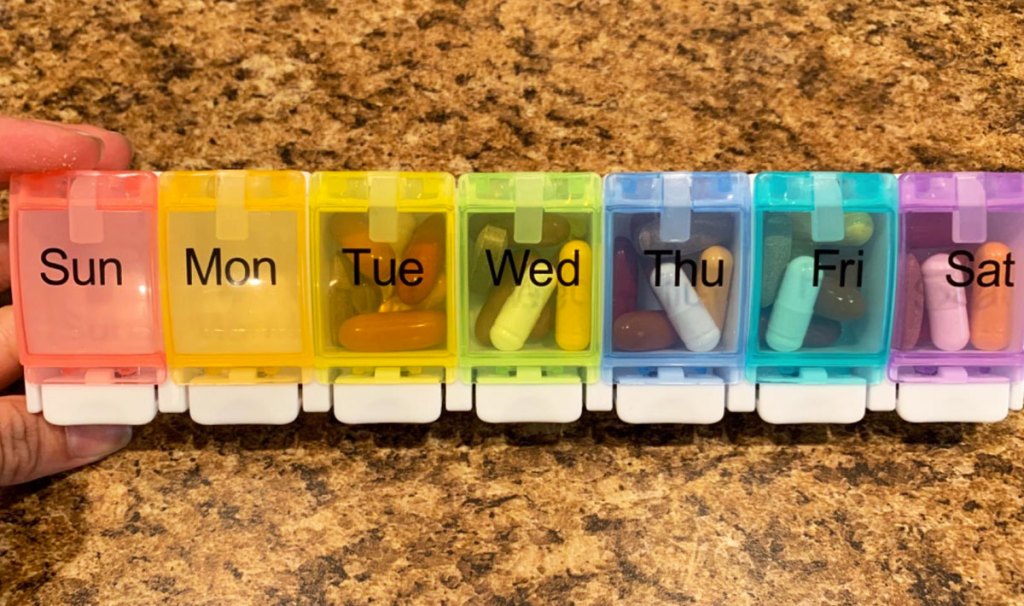 multi-colored weekly pill organizer box showing how many pills fit inside each compartment