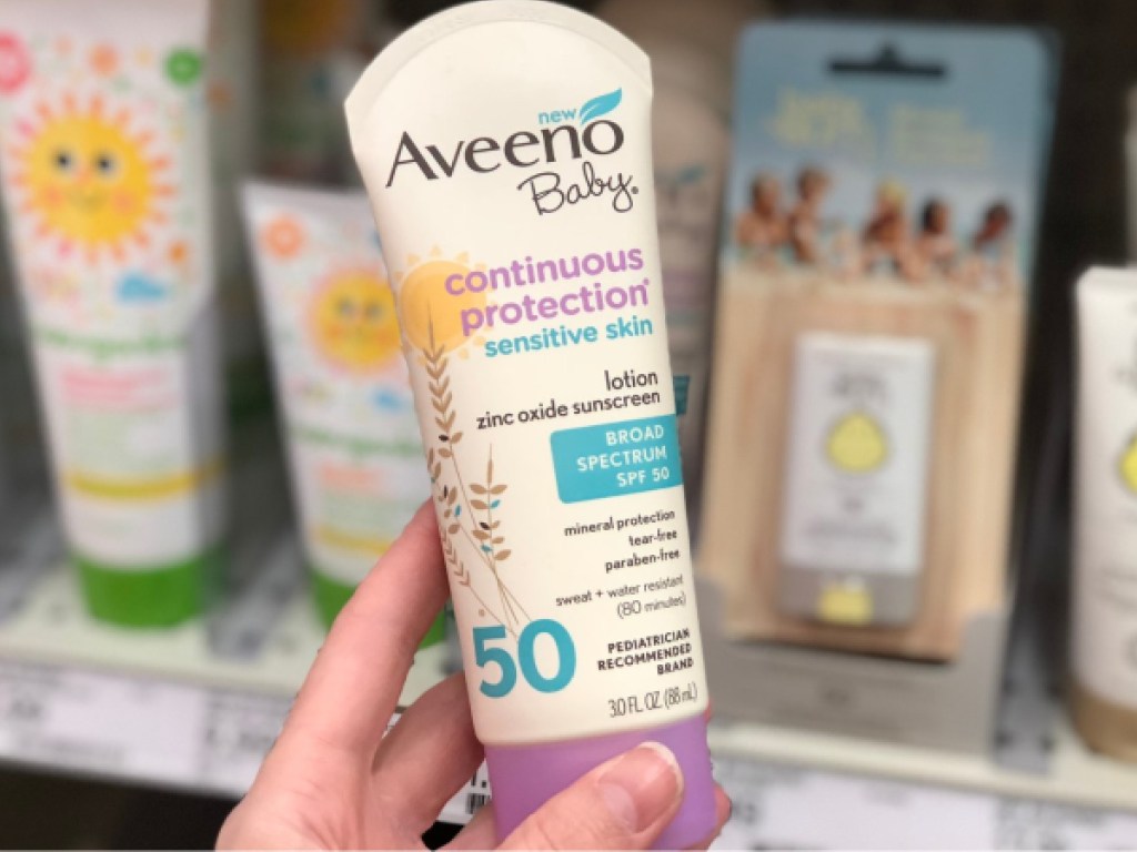 hand holding baby sunscreen in store