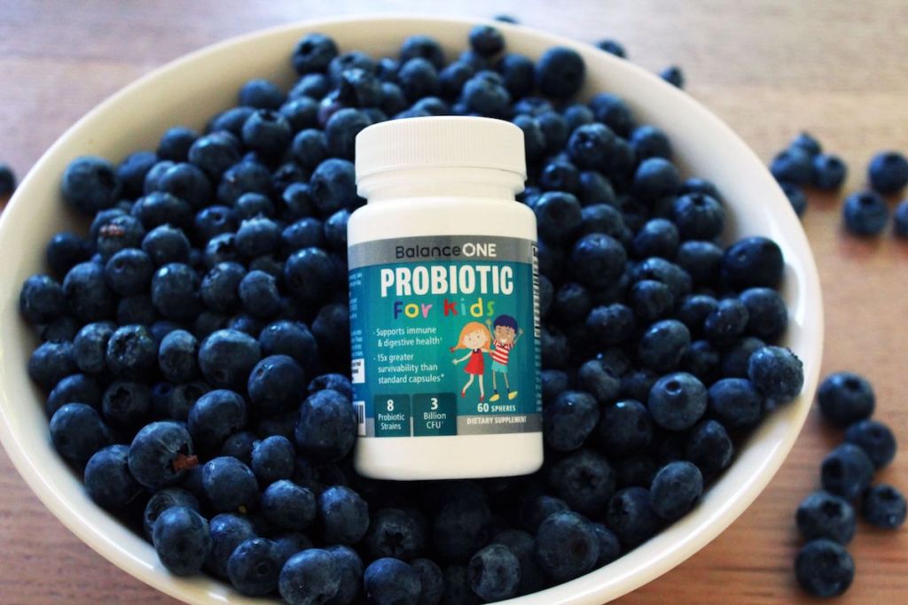 Balance One Kids Probiotics bottle in bowl of blueberries