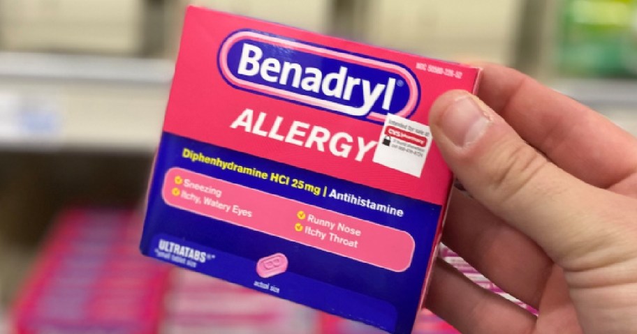 hand holding a box of Benadryl Allergy Tablets in -store