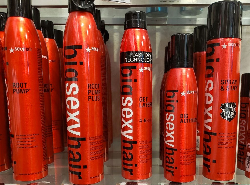 red and black bottles of sexy hair styling products on shelf