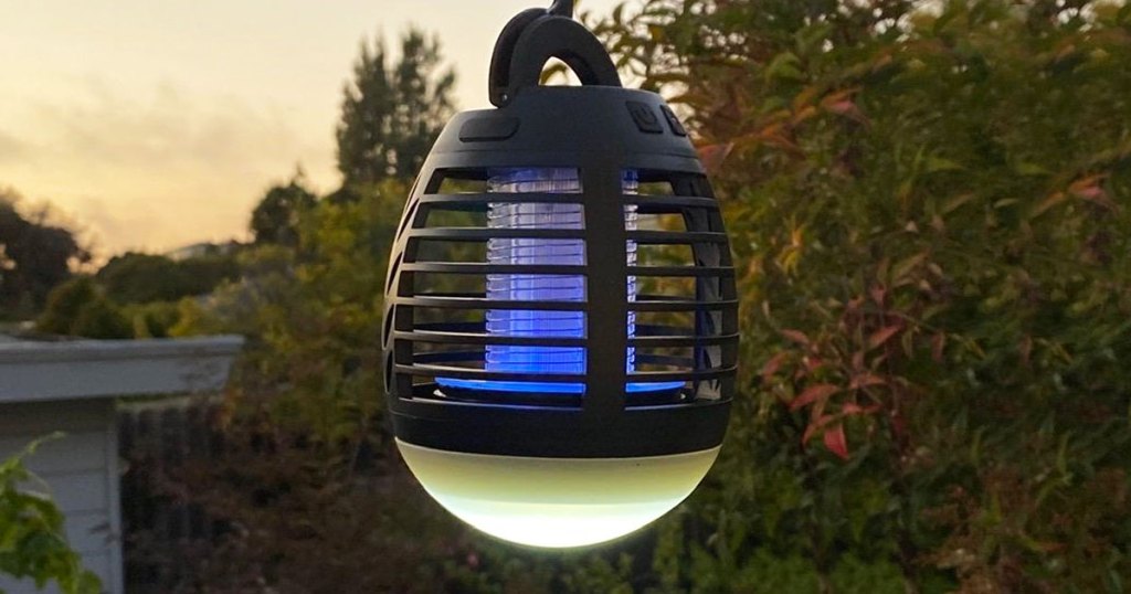 black plastic bug zapper outside with blue light and white led light