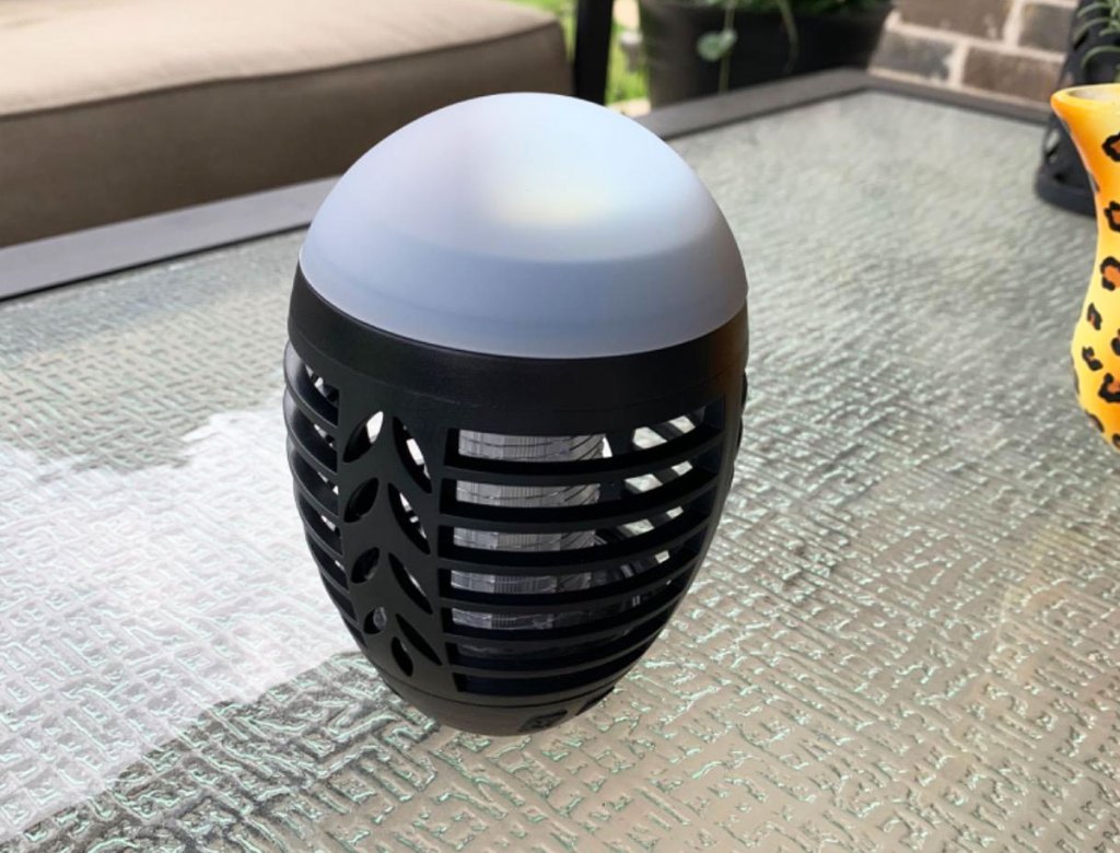 black plastic bug zapper on glass outdoor patio table