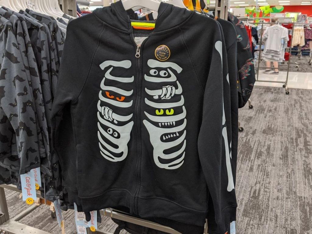 boys hoodie on hanger at store featuring skeleton graphic