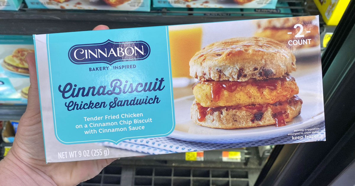 person holding up a blue box of Cinnabon chicken breakfast sandwiches
