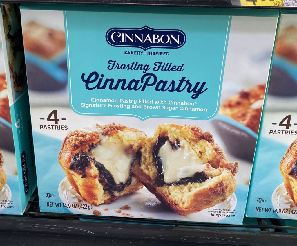 blue box of Cinnabon frosting-filled pastries on store freezer shelf
