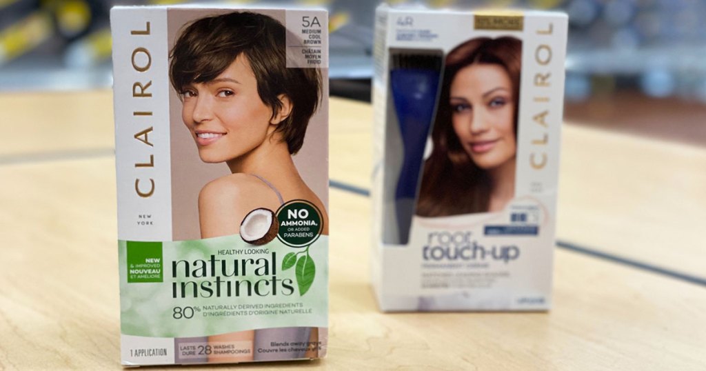 boxes of Clairol Natural Instincts and Root Touch-Up hair color on wood table
