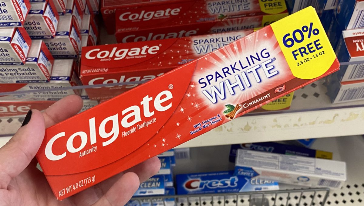 hand holding box of whitening toothpaste in store