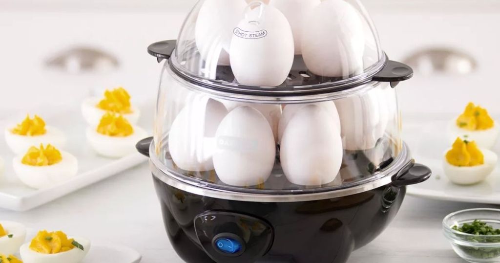 egg cooker surrounded by hard boiled eggs