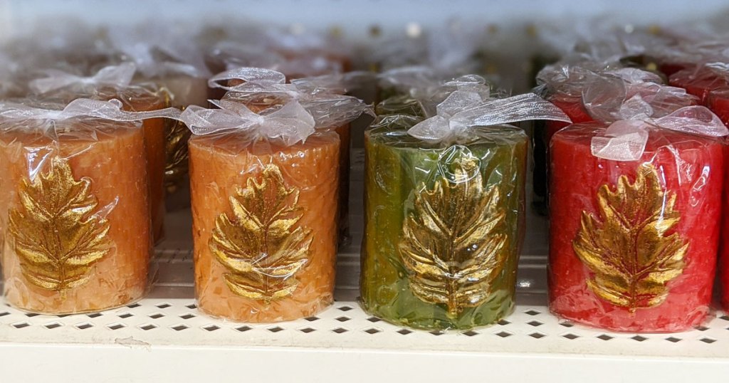 red, green, and yellow votive candles with gold leaves on them