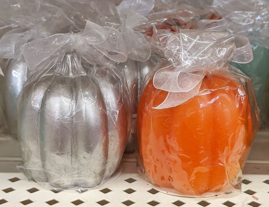 silver and orange colored pumpkin shaped candles wrapped in cellophane