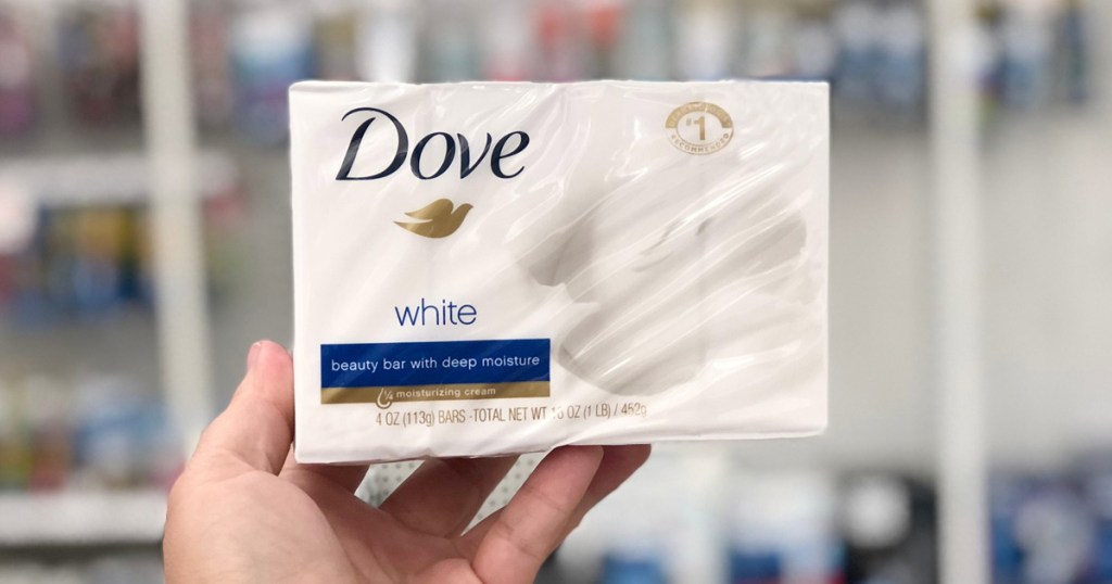 person holding up a white and blue box of Dove Beauty Bars