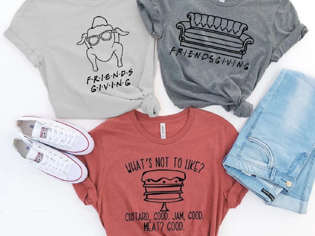 three Friendsgiving tees, jeans, and white sneakers
