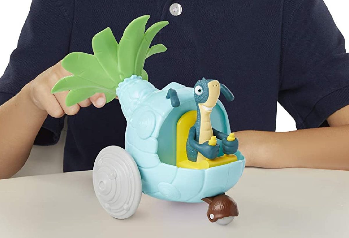 child playing with blue dinosaur toy vehicle