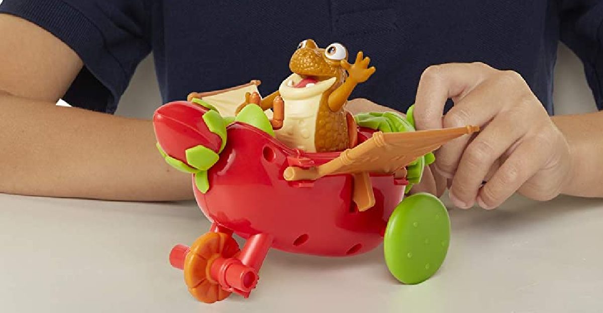 child playing with red dinosaur toy vehicle