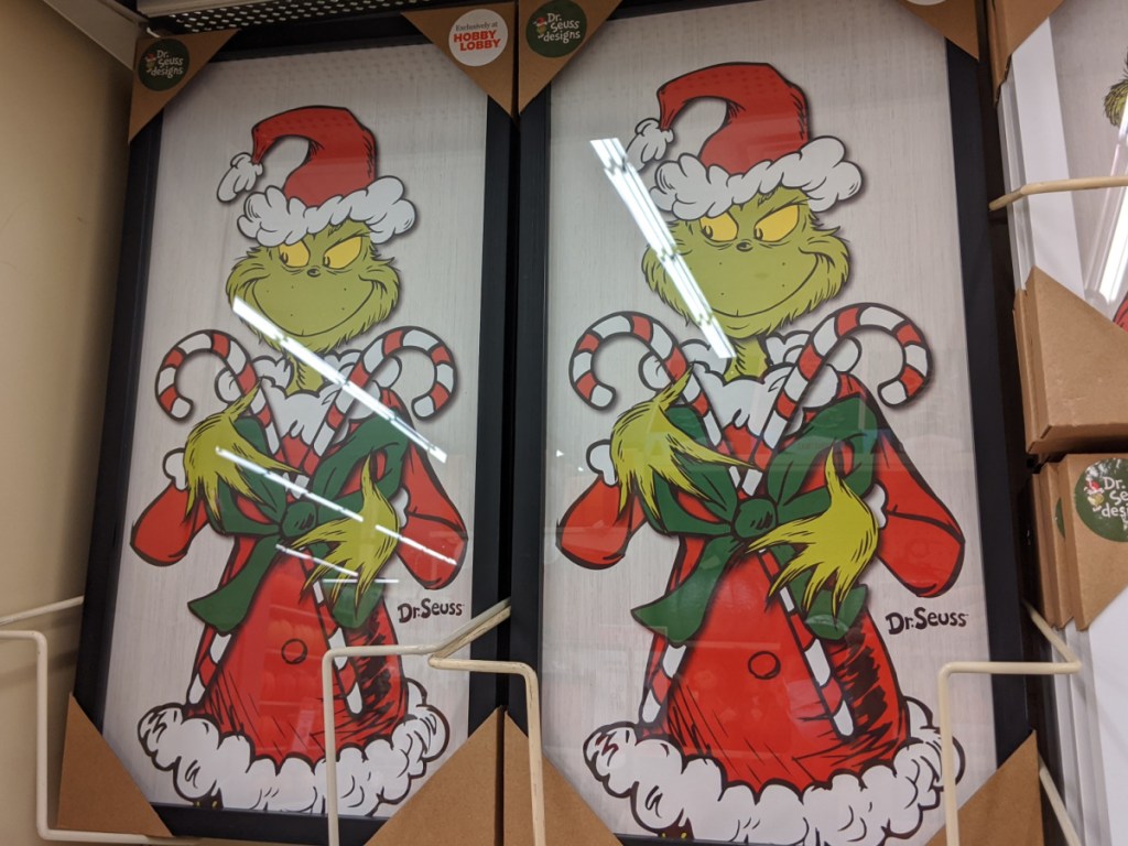 two Grinch framed wall decor on store shelf