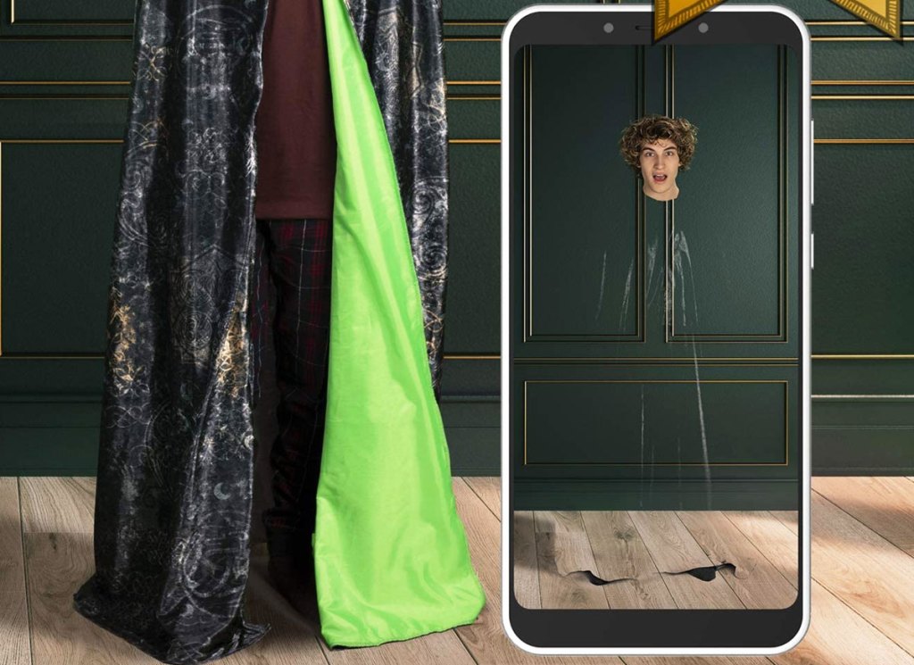 man wearing Harry Potter cloak and smartphone showing picture of him as only a floating head