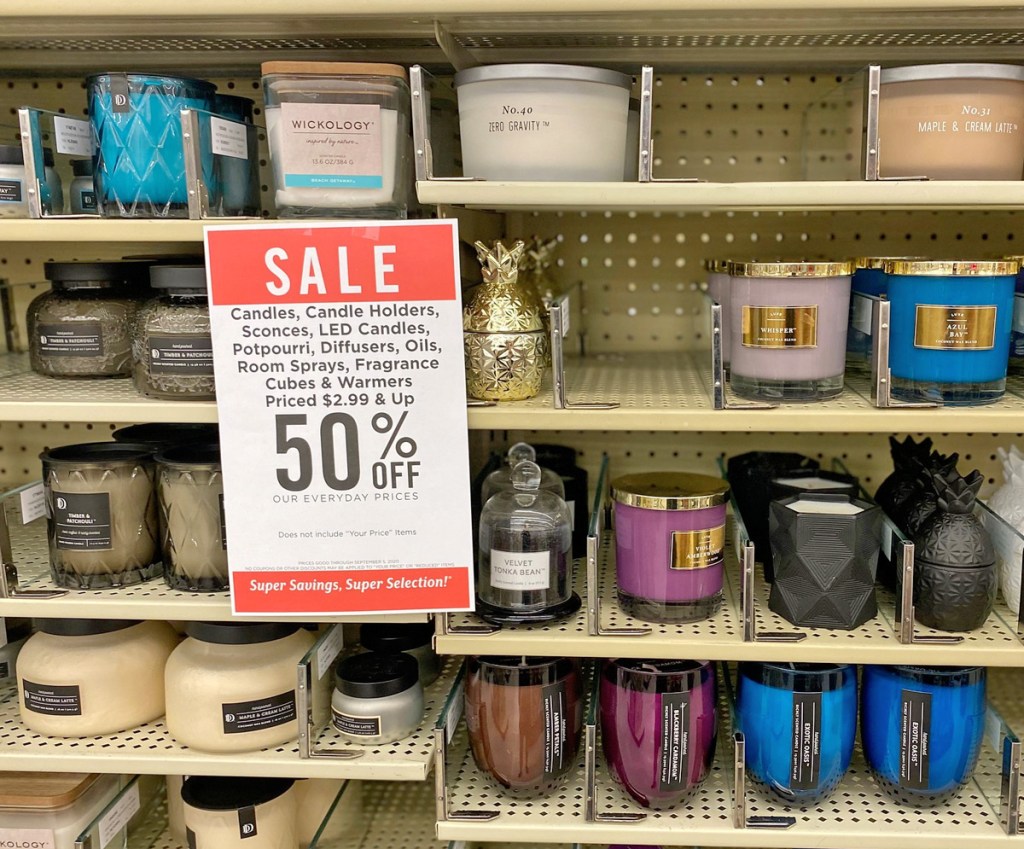 glass jar candles on store shelf with sale sign at Hobby Lobby
