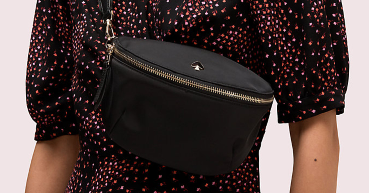 woman wearing a black and red top carrying a black and gold kate spade belt bag