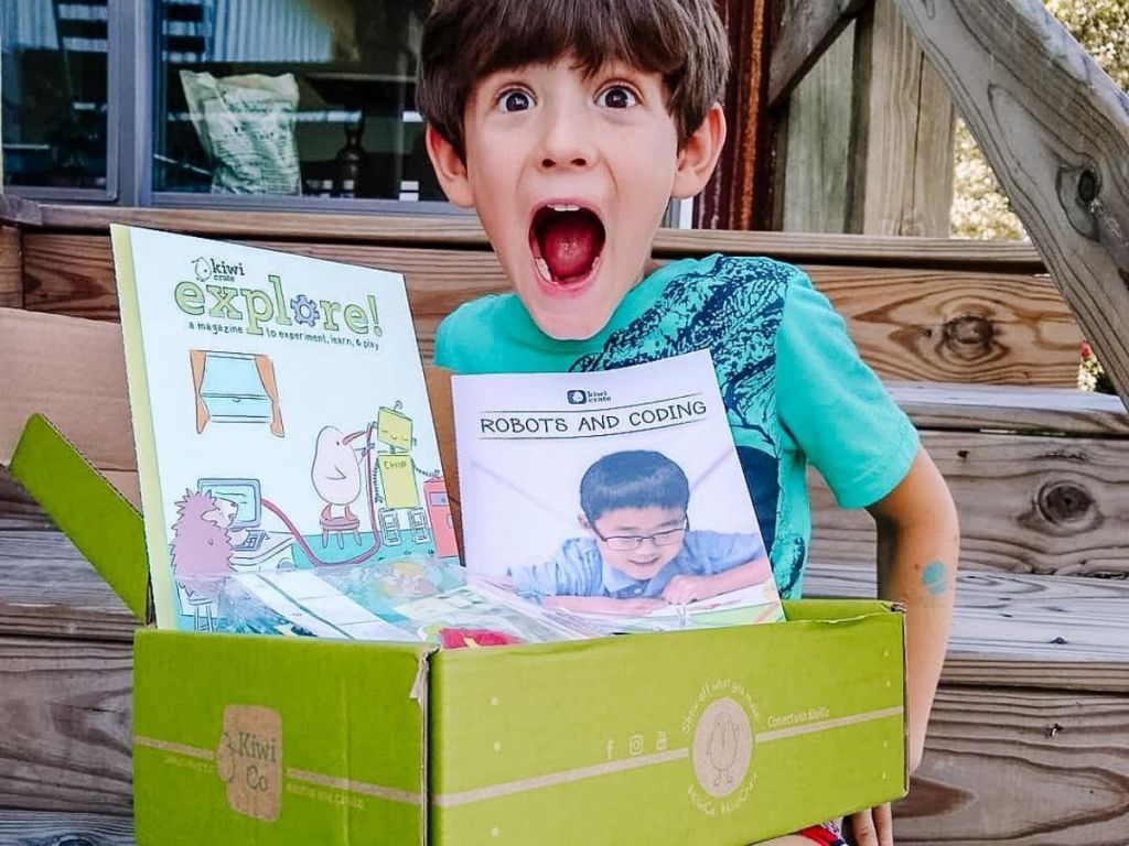 kid holding a kiwico box