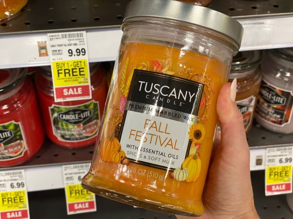 Large Jar candle in womans hand at Kroger store