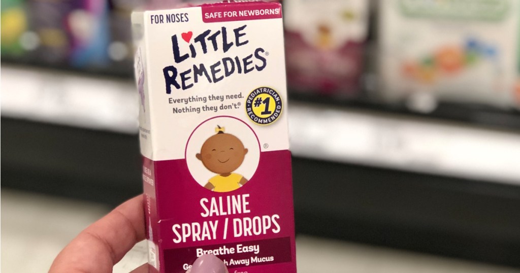 hand holding box of Little Remedies Saline Spray Drops in store