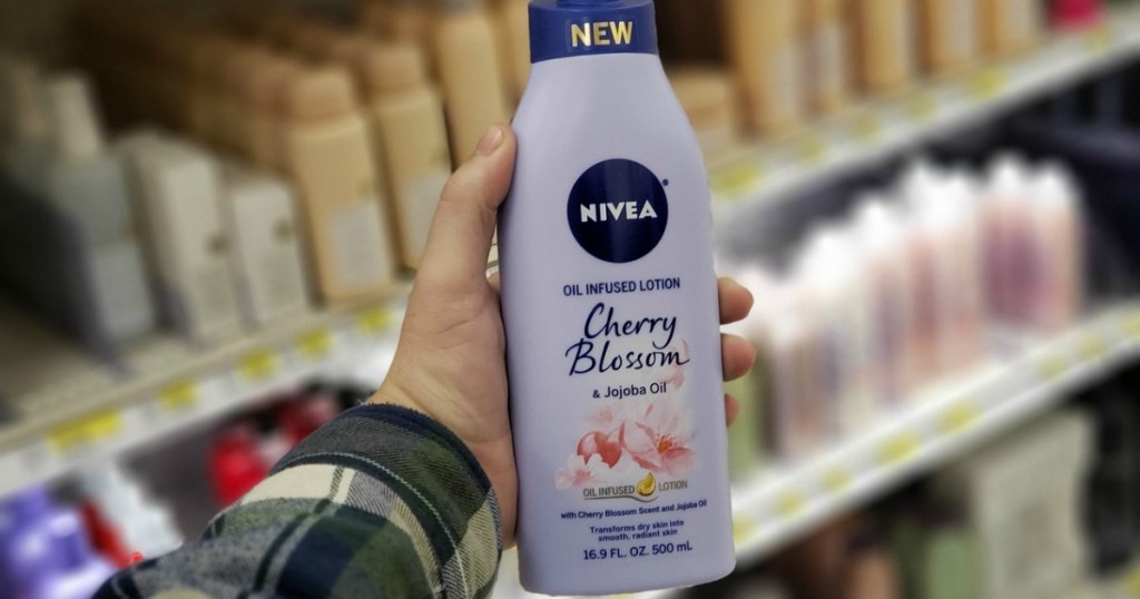 hand holding bottle of nivea cherry blossom lotion