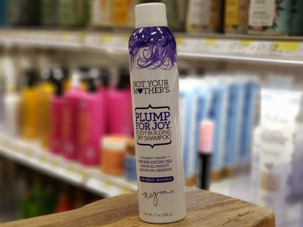 can of dry shampoo on wood surface in store