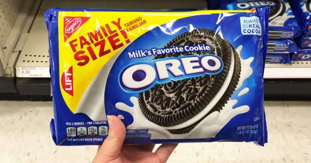 person holding up a family size package of oreo cookies