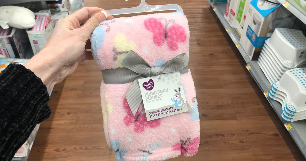 hand holding pink butterfly baby blanket in store