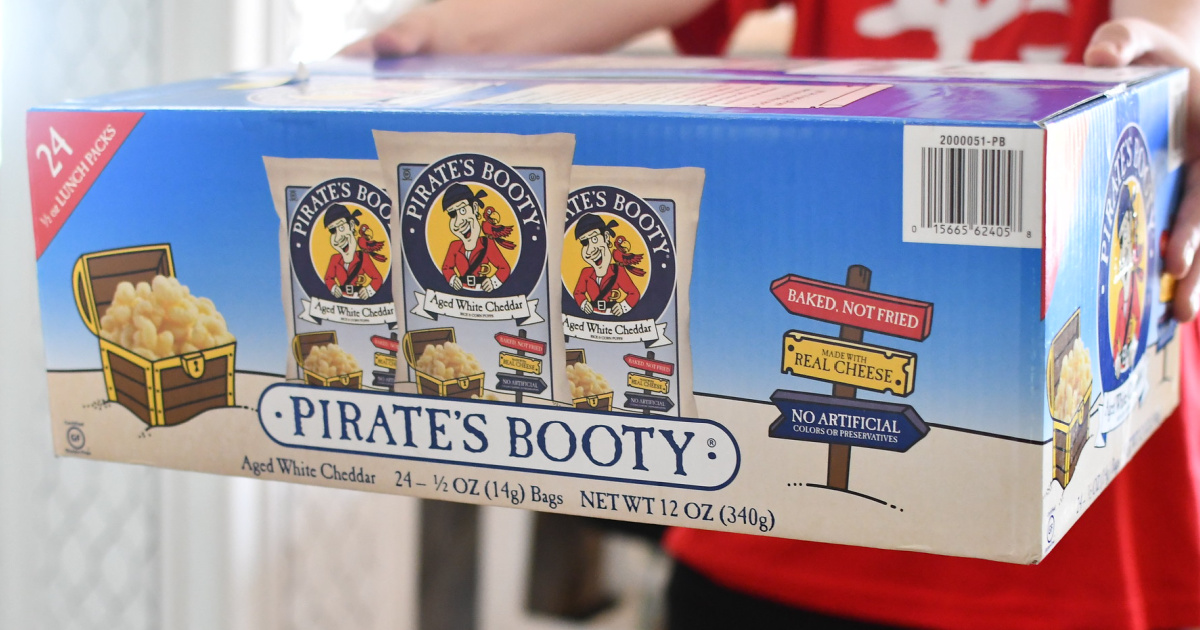 person holding a large 24-count box of pirates booty snacks