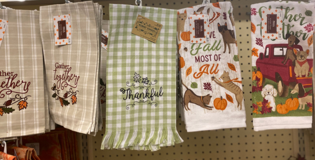 fall themed kitchen towels hanging in store