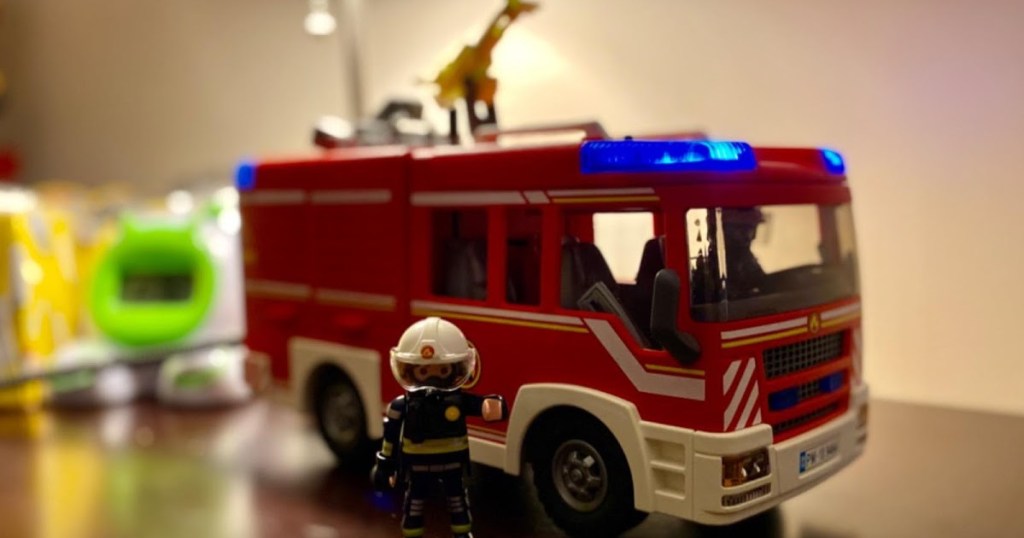 Playmobil fire truck and figure on dresser
