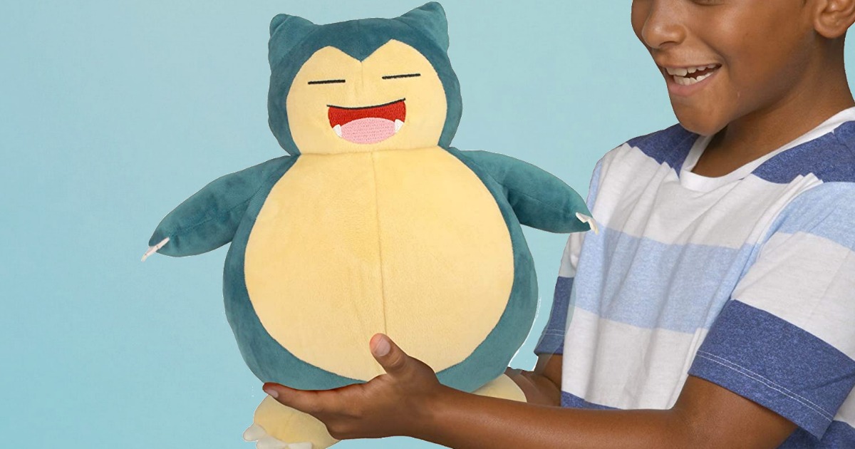 Large Pokemon plush toy being held by a young boy