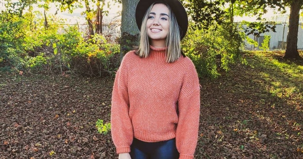 woman wearing coral sweater outdoors